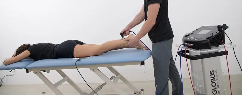 Chartered physiotherapist treating a sports injury in clinic